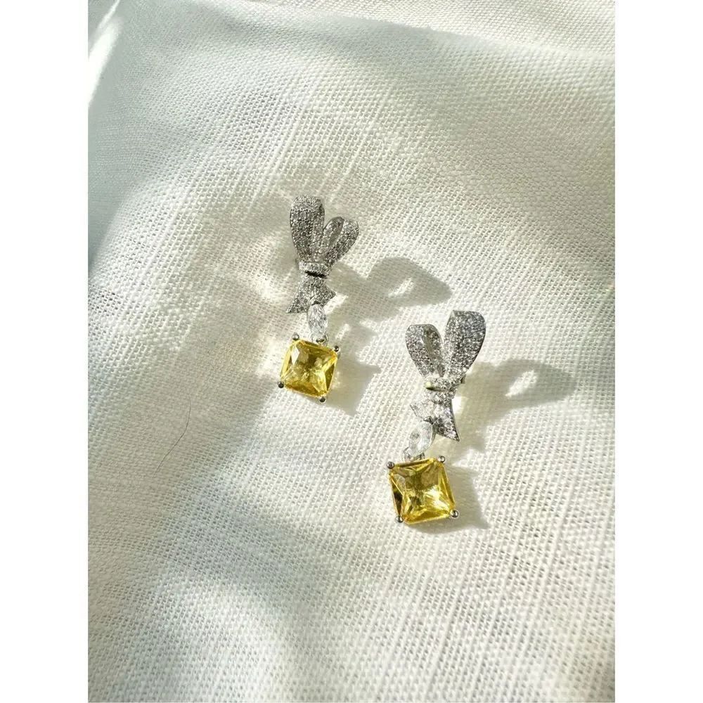 Cubic zirconia bow canary dangle earrings
